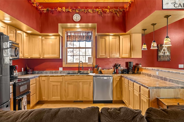 kitchen featuring pendant lighting, light brown cabinets, sink, and appliances with stainless steel finishes