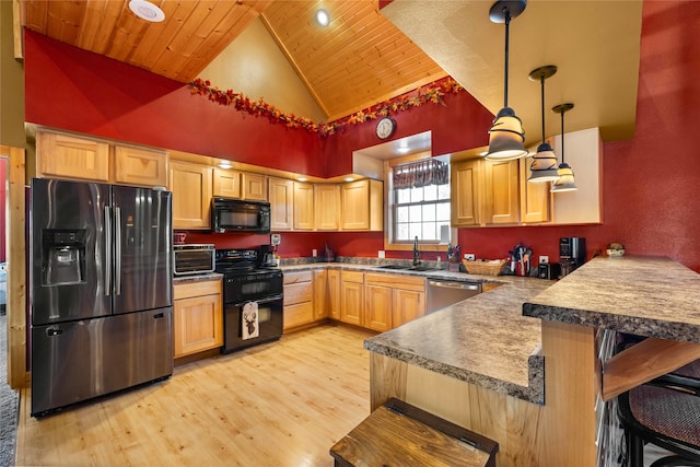 kitchen with a breakfast bar, black appliances, decorative light fixtures, kitchen peninsula, and wood ceiling