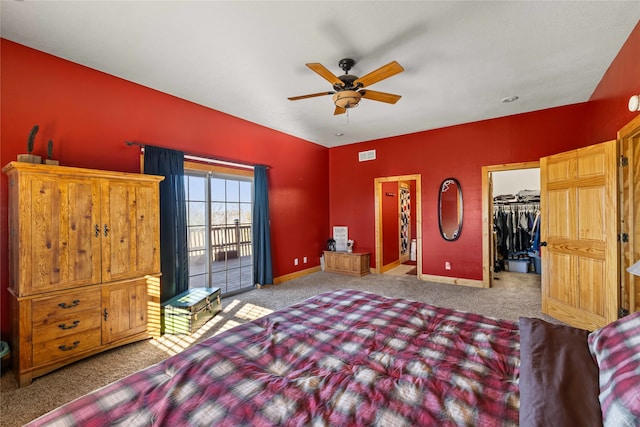 carpeted bedroom featuring access to outside, a spacious closet, a closet, and ceiling fan