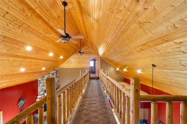 corridor featuring dark colored carpet, vaulted ceiling, and wood ceiling