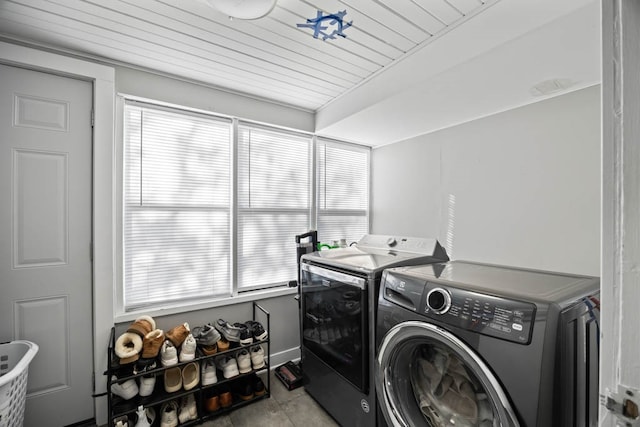 clothes washing area with plenty of natural light, independent washer and dryer, and wooden ceiling