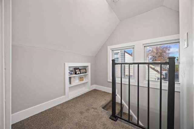 bonus room featuring carpet flooring and vaulted ceiling