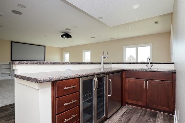 kitchen with stainless steel fridge, beverage cooler, dark wood-type flooring, and sink