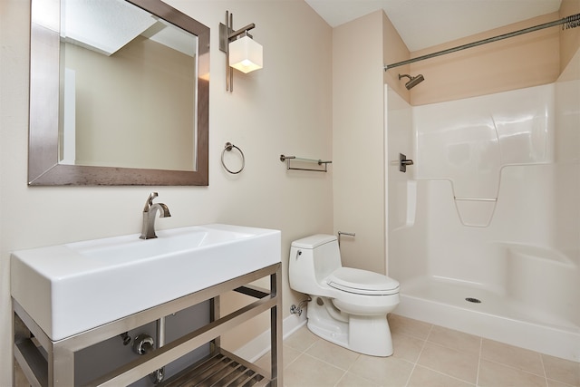 bathroom featuring a shower, tile patterned flooring, and toilet