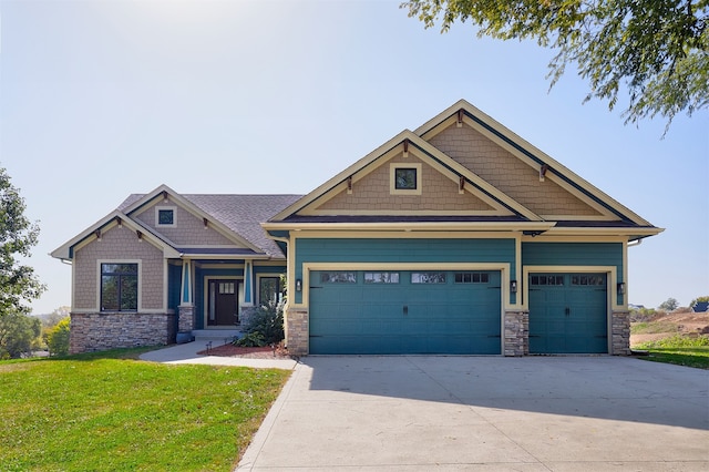 craftsman-style house featuring a garage and a front lawn