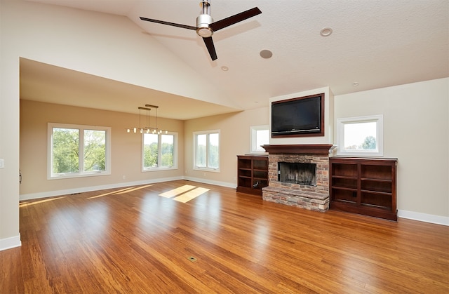 unfurnished living room with a fireplace, a healthy amount of sunlight, and hardwood / wood-style flooring