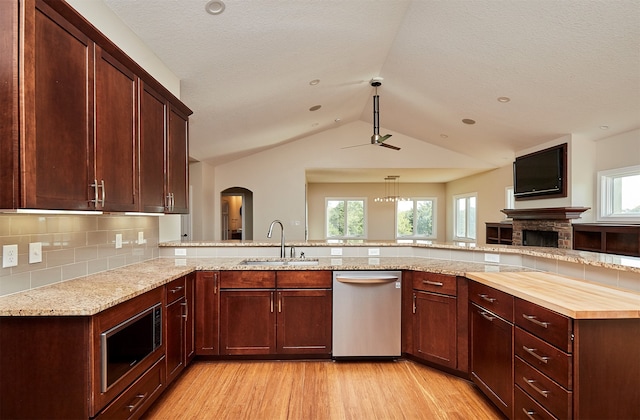 kitchen with appliances with stainless steel finishes, light hardwood / wood-style flooring, a healthy amount of sunlight, and sink