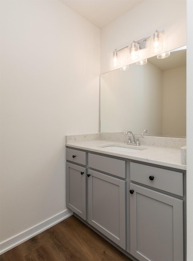 7011 Lincoln Cir, Johnston, IA 50131 - bathroom with vanity, wood finished floors, and baseboards