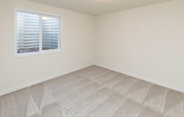 7011 Lincoln Cir, Johnston, IA 50131 - carpeted empty room with baseboards