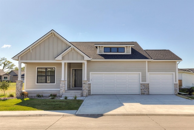 7011 Lincoln Cir, Johnston, IA 50131 - craftsman house with stone siding, driveway, a shingled roof, a garage, and board and batten siding