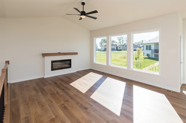 unfurnished living room with ceiling fan, dark wood-type flooring, and vaulted ceiling