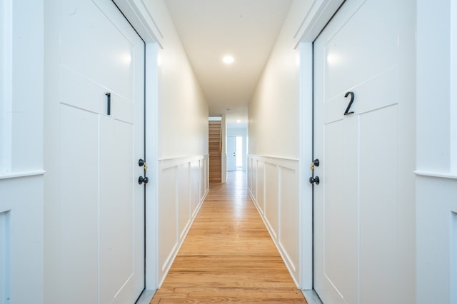 corridor with light hardwood / wood-style floors