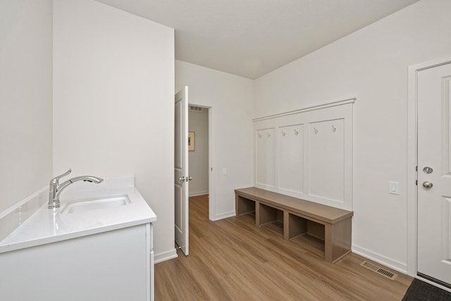 mudroom featuring sink and light hardwood / wood-style flooring