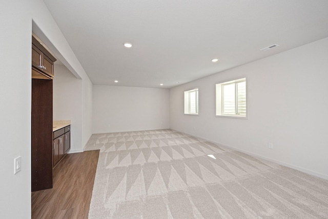 unfurnished living room featuring light colored carpet