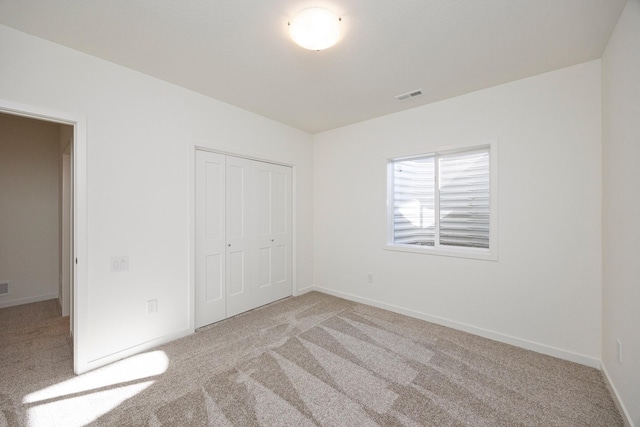 8916 Beery Pl, Johnston, IA 50131 - unfurnished bedroom with carpet, a closet, and baseboards