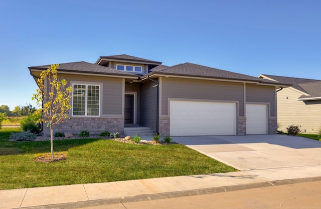 8916 Beery Pl, Johnston, IA 50131 - prairie-style house with an attached garage, stone siding, driveway, and a front yard