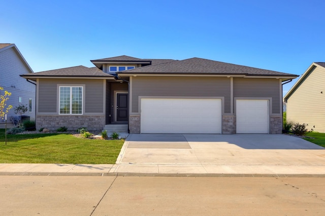8916 Beery Pl, Johnston, IA 50131 - prairie-style home with stone siding, a garage, driveway, and a front lawn
