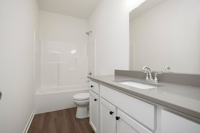 full bathroom with vanity, wood-type flooring, tub / shower combination, and toilet