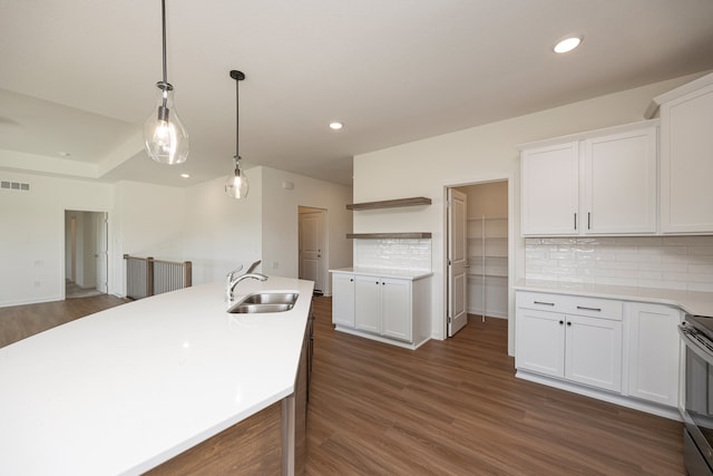 kitchen with white cabinets, pendant lighting, and dark wood-type flooring