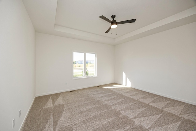 8916 Beery Pl, Johnston, IA 50131 - carpeted spare room featuring a ceiling fan, a raised ceiling, and baseboards