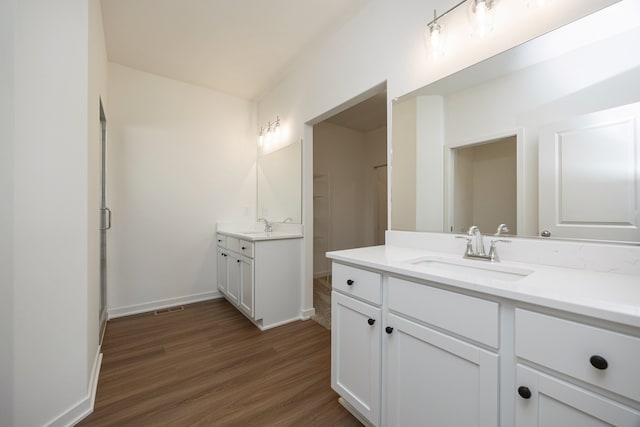 bathroom with vanity and wood-type flooring