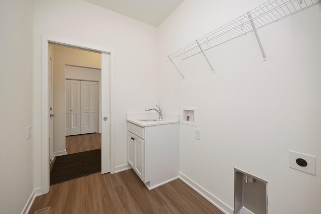 8916 Beery Pl, Johnston, IA 50131 - laundry area with dark wood finished floors, cabinet space, hookup for a washing machine, electric dryer hookup, and baseboards