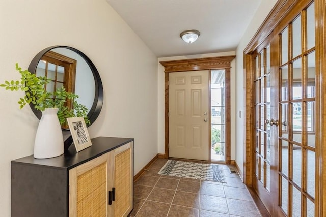 tiled entryway featuring french doors