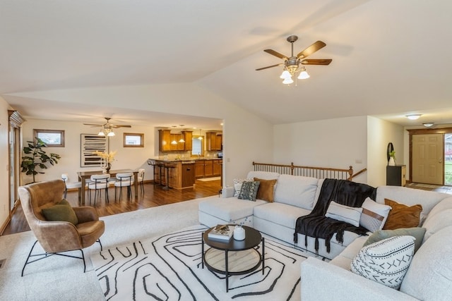 living room with vaulted ceiling, plenty of natural light, and ceiling fan