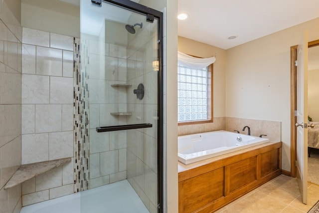 bathroom featuring tile patterned flooring and independent shower and bath