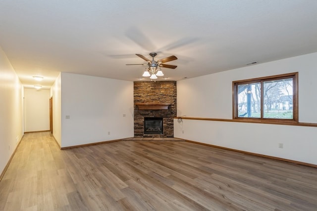 unfurnished living room with a fireplace, light hardwood / wood-style floors, and ceiling fan