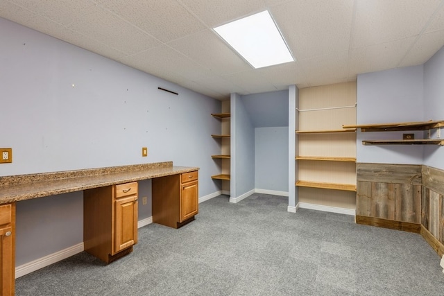 unfurnished office featuring light carpet and built in desk