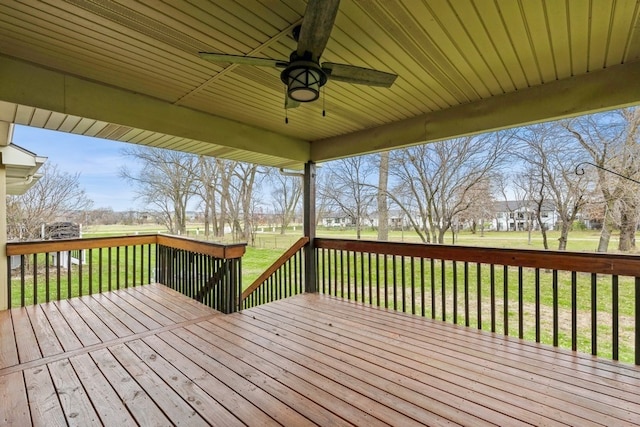 deck with a lawn and ceiling fan