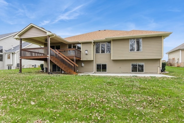 rear view of property with a lawn and a wooden deck