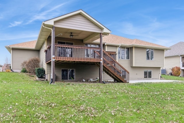 rear view of property with ceiling fan, a yard, and a deck