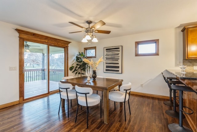 dining space featuring dark hardwood / wood-style flooring, ceiling fan, and a healthy amount of sunlight