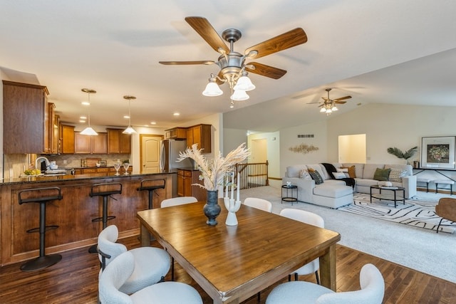 dining space featuring ceiling fan, dark hardwood / wood-style flooring, and lofted ceiling