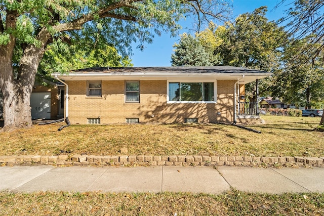 view of front of property with a front yard and brick siding