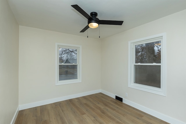 spare room with light hardwood / wood-style flooring and ceiling fan