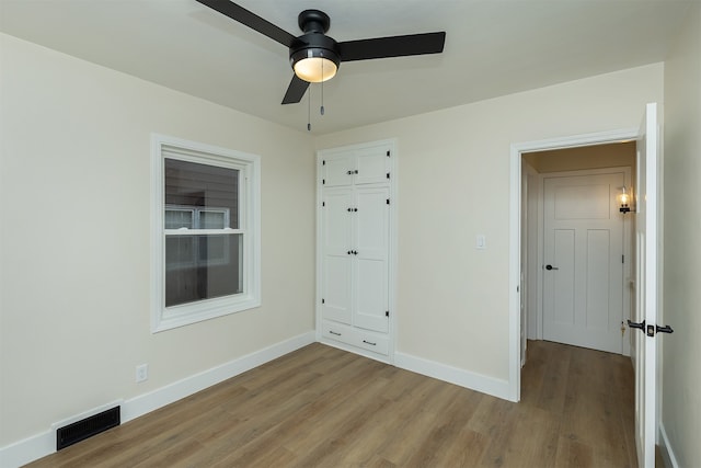 interior space with ceiling fan, light hardwood / wood-style floors, and a closet