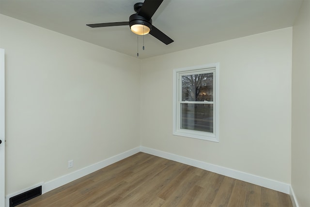 empty room with ceiling fan and light hardwood / wood-style floors