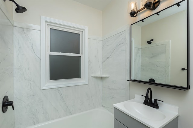 bathroom featuring vanity and tiled shower / bath