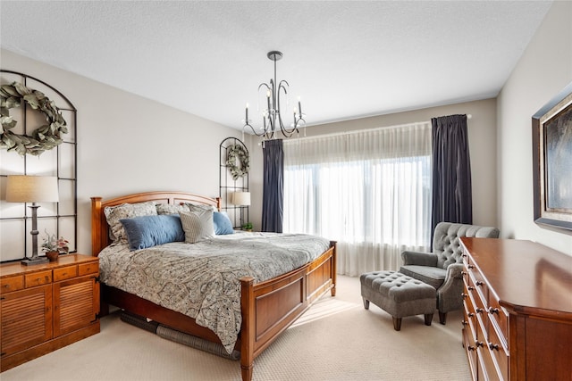 bedroom with light colored carpet, an inviting chandelier, and a textured ceiling