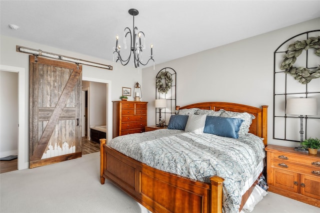 carpeted bedroom featuring a barn door, an inviting chandelier, and connected bathroom