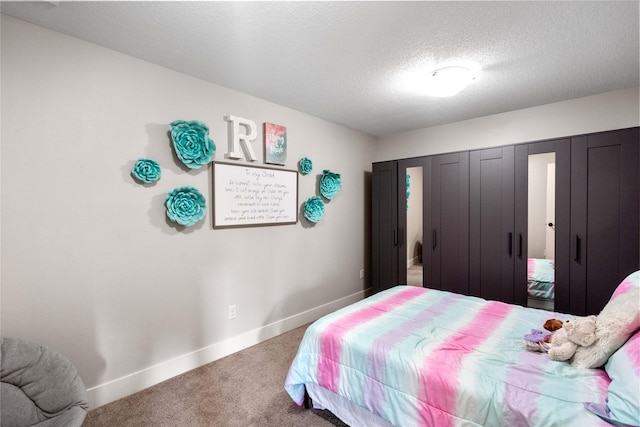 bedroom with carpet floors and a textured ceiling