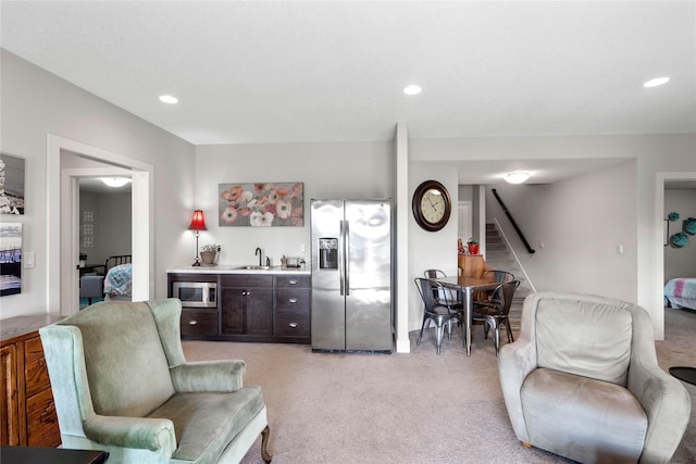 carpeted living room featuring sink