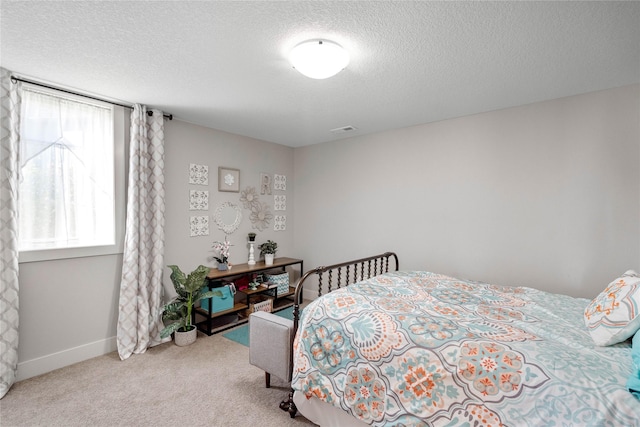 carpeted bedroom featuring a textured ceiling