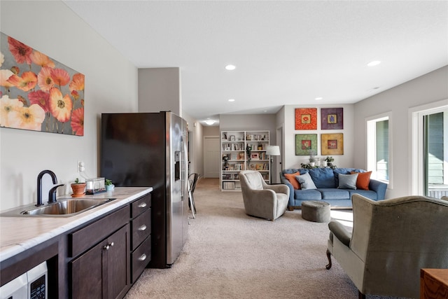 carpeted living room with sink