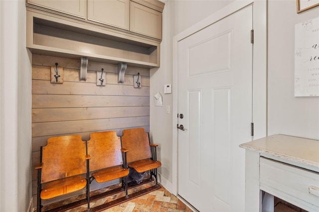 mudroom with wood walls