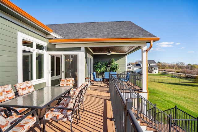 deck featuring ceiling fan and a yard