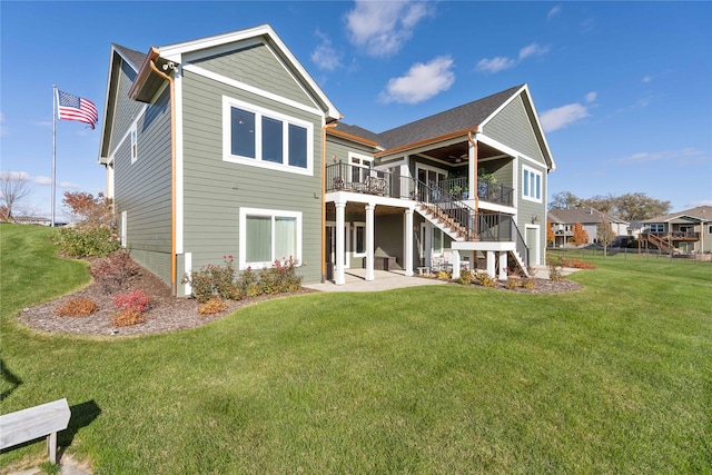 rear view of property with ceiling fan, a deck, a patio, and a yard